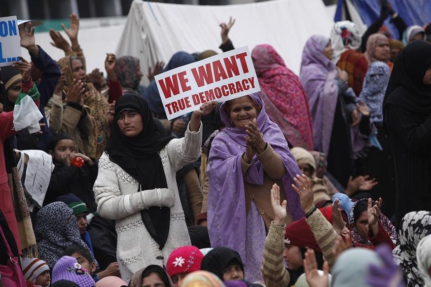 Ladies holding a sign that says we want democracy