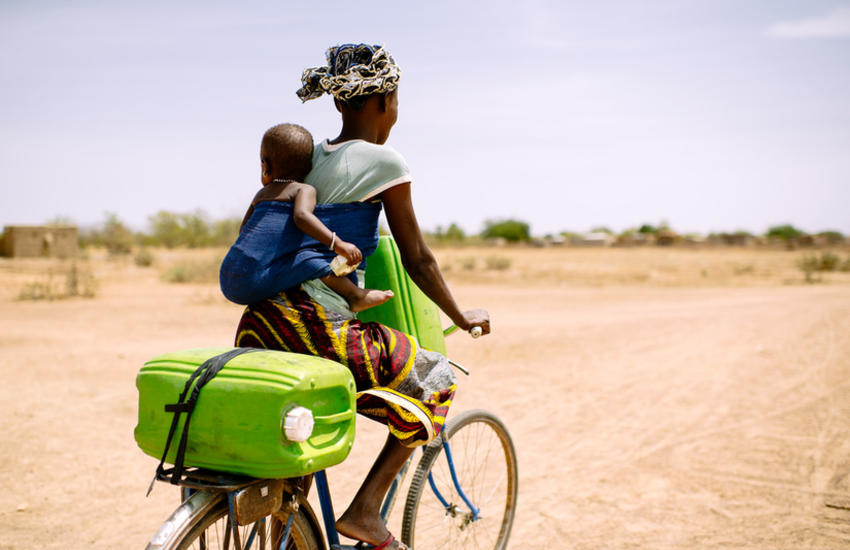 Woman cycling with child