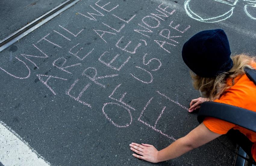 Person writing on the road: human rights day in Australia