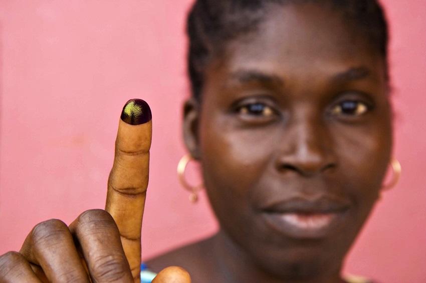 Woman holding up an inked finger / © Joseph Penney / Reuters