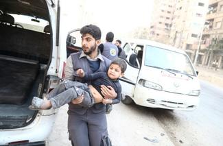 Man carries child in Syria