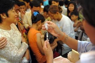 A Cambodian nurse fills her syringe with a vaccine to help protest against influenza A(H1N1), or swine flu, at the Cambodian People's Party headquarters (CPP) in Phnom Penh on July 2, 2010