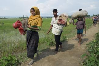 People belonging to the ethnic minority Rohingyas of Myanmar (Burma) cross the Bangladesh border to arrive at the Balukhali camp in Cox's Bazar, Bangladesh on September 07, 2017