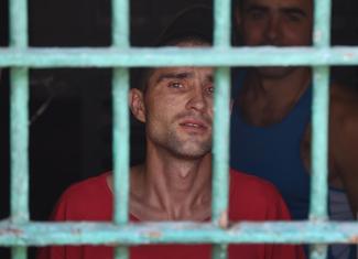 A prisoner looks out from prison cell of Lukyanivska prison in Kiev on July 6, 2018