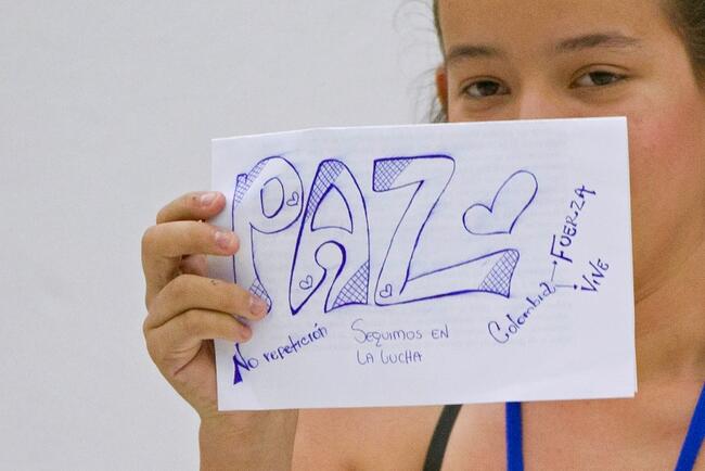 Young girl holding up a peace sign