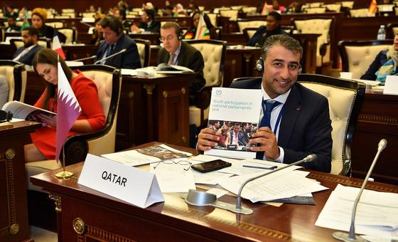MP holding up an IPU publication at the 5th Global Conference of Young MPs
